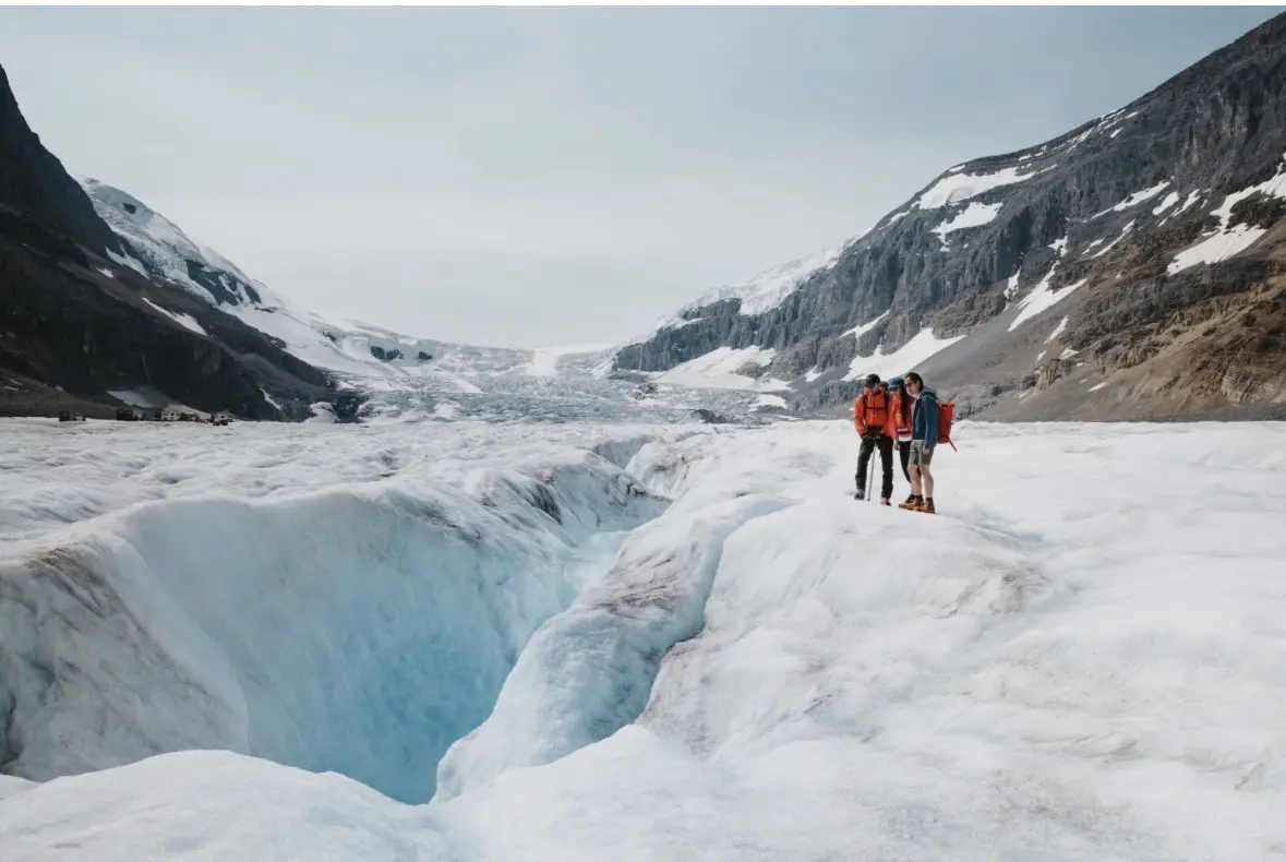 Travellers viewing glacial ice at the Columbia Icefield in the Canadian Rockies